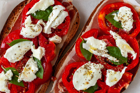 ham, tomato and mozarella toasts, top viewの写真素材