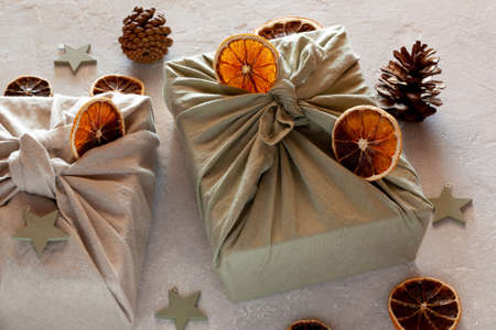 Christmas gifts textile packed, decorated with natural materials, zero waste conceptの写真素材