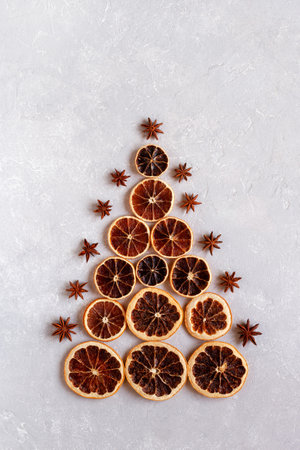 Christmas tree made of dry orange slices and decorated with anise stars, zero waste idea, top viewの写真素材