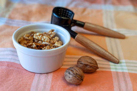 fresh walnuts with a cracker on a tableの写真素材