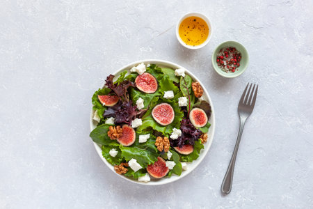 portion of fig, salad leaves, feta and walnuts salad, top viewの写真素材