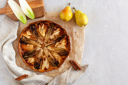 Homemade endive, pear and gorgonzola tart, flatlay, copy spaceの写真素材