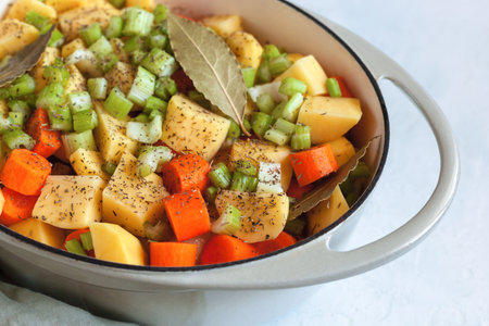 Slices of vegetables prepared for cooking in the ovenの写真素材