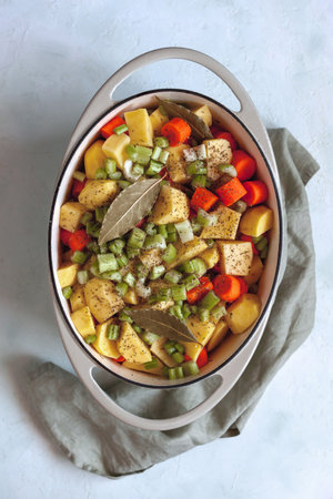 Oval cast iron stewpan with mixed vegetablesの写真素材
