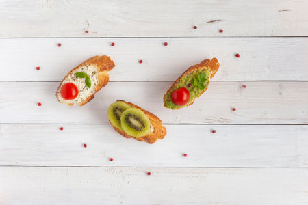 Three mini toasts surrounded by red berries, heart shape, Valentines Day conceptの写真素材