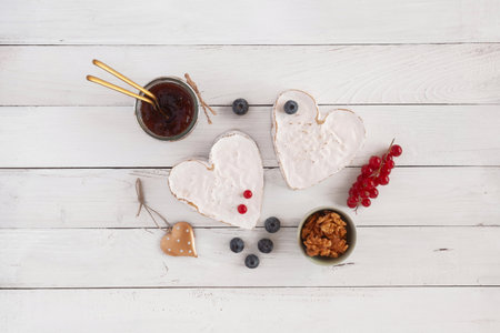 Heart shape cheese, jam and berries on a table, idea of Valentine Day foodの写真素材