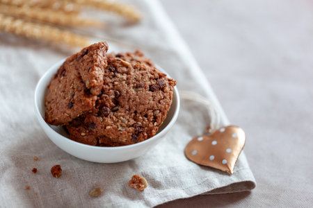Homemade cookies with cereal and seeds, bowl on a tableの写真素材