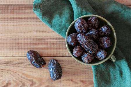 Dates fruits in a bowl, top view, copyspaceの写真素材