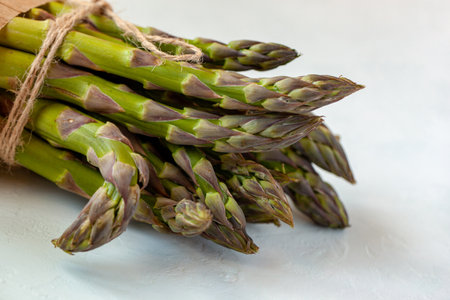 bunch of fresh organic.asparagus diagonal on the light blue background, top viewの写真素材