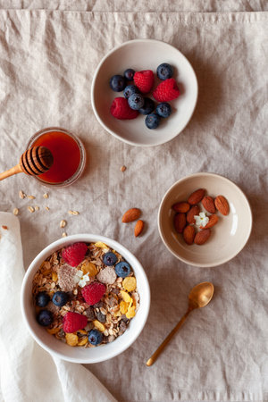 Portion of morning breakfast of oat flakes, fresh berries, almonds and honeyの写真素材