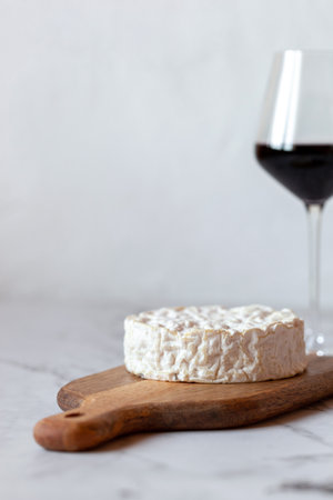 Camembert cheese served with a glass of wineの写真素材