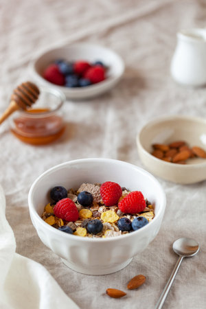 Oat flakes breakfast portion with raspberries, blueberries and honeyの写真素材