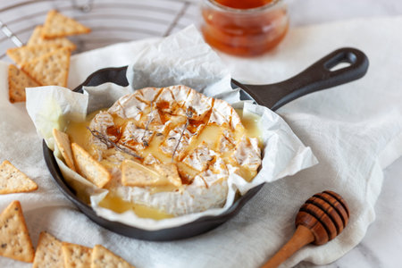 Camembert soft french cheese cooked in the oven with honey and thymeの写真素材