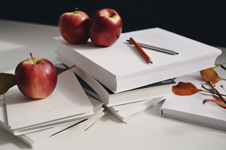 Sketching papers, books, apples and dry leaves on a table, concept of creation, Generative AIの素材
