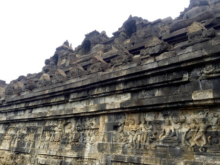 relief carving of borobudor pyramid on the walls of borobudur ruins near yogyakarta in java indonesiaの写真素材