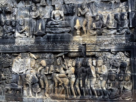 relief carving of borobudor pyramid on the walls of borobudur ruins near yogyakarta in java indonesiaの写真素材