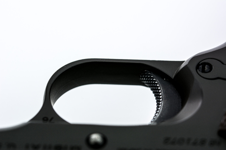 Trigger of gun on white background