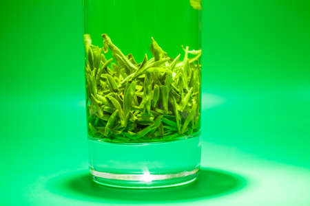 Fresh tea leaves in a glassの写真素材
