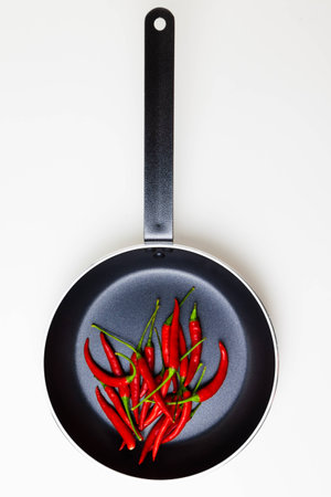 Red peppers in the panの写真素材