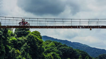 People riding on motorcycle to pass a robe bridgeのeditorial素材