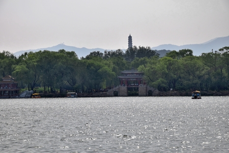 Kunming Lake located on the grounds of the Summer Palace in Beijing with Tower of Buddhist Incense in the background.のeditorial素材