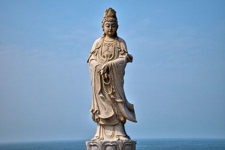 The statue of the Guanyin Boddhisatva in the Chicken Island near Maoming, Guangdong Province, China.の写真素材