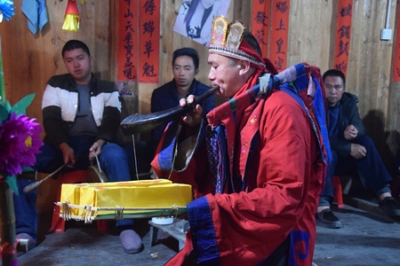 GUIZHOU PROVINCE, CHINA CIRCA DECEMBER 2018: The ritual redeeming the vow in a village of Guizhou accompanied by theatrical performance did by the ritual masters. Translation of text: worship nature and ancestors.のeditorial素材