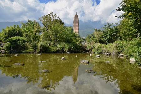 Reflection Pond mirroring the image of the Three Pagodas of the Chongsheng Temple near the old town of Dali in Yunnan province in China.のeditorial素材