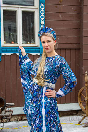 Russian girl in Russian national costumesof winter in a village