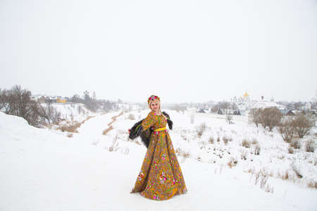 beautiful Russian girl in a winter national dress