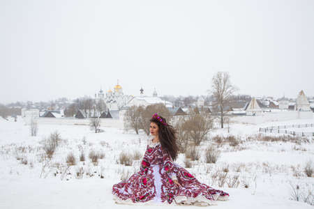 beautiful Russian girl in a winter national dressの写真素材