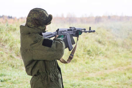 Man shooting at a target. Unformal shooting range