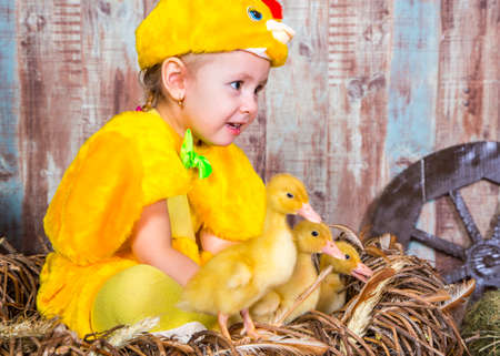 Cute girl play with real rabbit and duckling