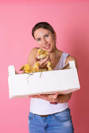 girl with cute duckling on color backgroundの写真素材