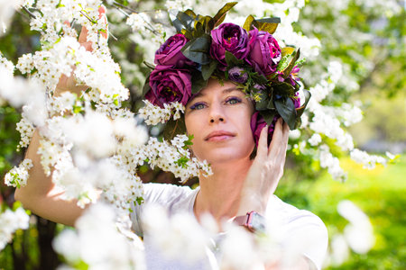 Beautiful young lady in the garden of cherry blossomsの写真素材
