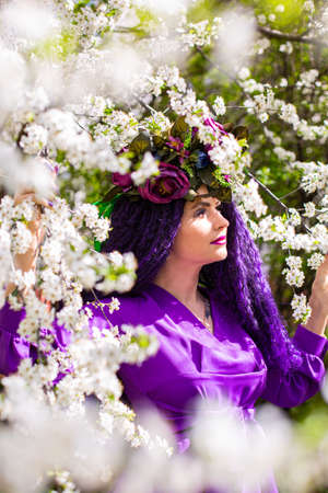 Beautiful young lady in the garden of cherry blossomsの写真素材