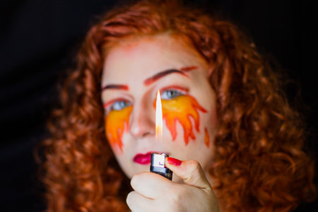 Portrait of a girl with a fiery make-upの写真素材