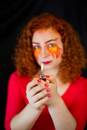 Portrait of a girl with a fiery make-upの写真素材