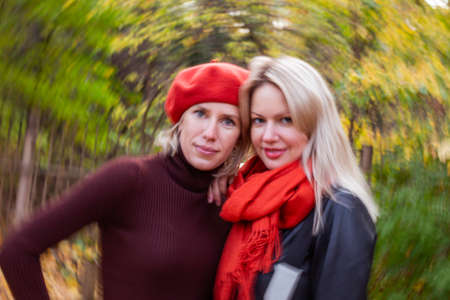 happy smiling womans holding in her hands yellow maple leavesの写真素材
