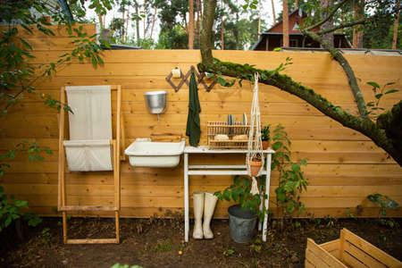 simple cottage and well on backyard in villageの写真素材