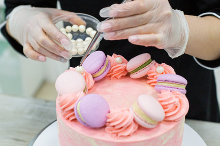 Pastry chef in the kitchen decorating a cakeの写真素材