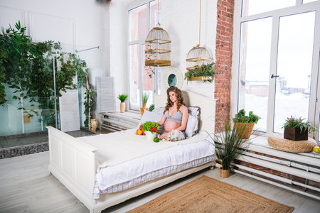 healthy nutrition and pregnancy. pregnant womans belly and vegetable saladの写真素材