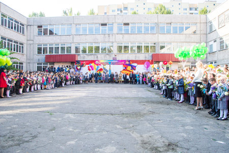 Meeting with the first-grade pupils and teacher at schoolyard. The day of knowledge in Russia.のeditorial素材