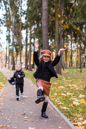 Cute children playing and laughing on autumn walkの写真素材