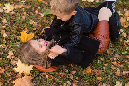 Cute children playing and laughing on autumn walkの写真素材