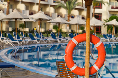 Sunbeds near swimming pool at luxury resort