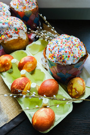 Close-up view of chicken eggs, homemade easter cake and willow twigs