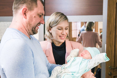 A Mother and father with her newborn baby at the home