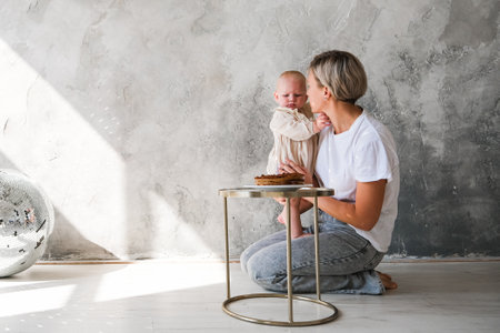 Baby girl celebrating her birthday with birthday cakeの写真素材
