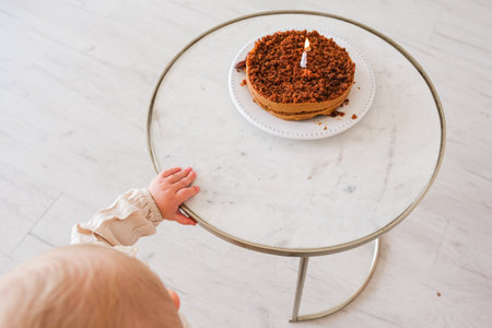 Baby girl celebrating her birthday with birthday cakeの写真素材